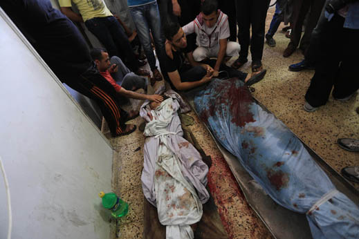 Palestinian relatives mourn over the body of Mahmud al-Sewati during his funeral